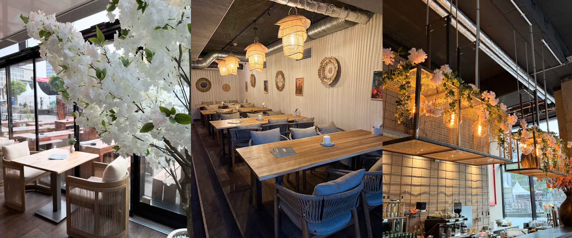 Modernes Restaurant mit Holztischen Rattanlampen und weisser Bluetendeko